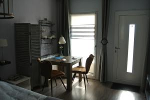 a bedroom with a table and chairs and a bed at B&B Von Clermont Park in Vaals
