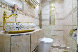 a bathroom with a sink and a toilet at Queen Stay Apartments in Sheffield