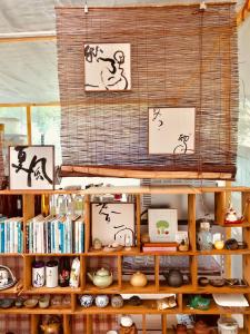 a shelf with some drawings of people on it at Real Food Kitchen Nature Stay B&B in Yuchi