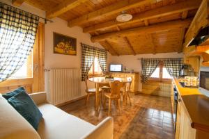 eine Küche und ein Wohnzimmer mit einem Tisch und Stühlen in der Unterkunft Appartamento Paola in Livigno