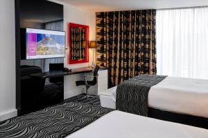 a hotel room with a television and a bed at Crowne Plaza Manchester City Centre, an IHG Hotel in Manchester