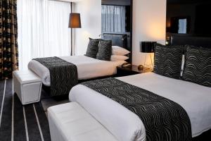 a hotel room with two beds and two nightstands at Crowne Plaza Manchester City Centre, an IHG Hotel in Manchester