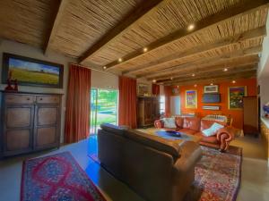 a living room with a couch and a tv at The Welgemoed Guest House in Bellville