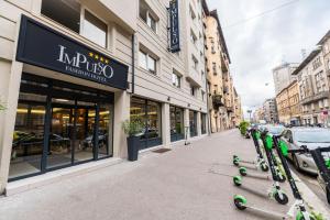 a row of scooters parked on a sidewalk in front of a store at Impulso Fashion Hotel in Budapest