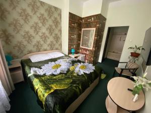 a bedroom with a bed with flowers on it at Hotel ALTEYA in Moscow