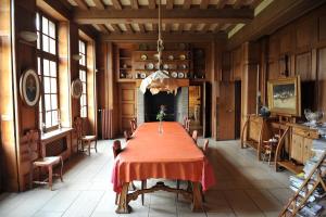 a large dining room with a table and chairs at Le Logis d'Arniere in Saint Cyr-sous-Dourdan