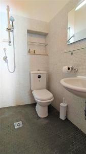 a bathroom with a toilet and a sink at Casa Aranci in Acireale