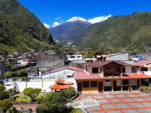 a view of a town with a mountain in the background at Hostal Monte Carmelo in Baños