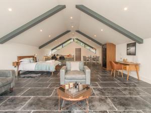 a bedroom with a bed and a living room at Boathouse on the Lake in Windermere