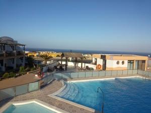 a large swimming pool on top of a building at Apartamento LE SOLEIL Complex Amaya Fuerteventura in Costa de Antigua