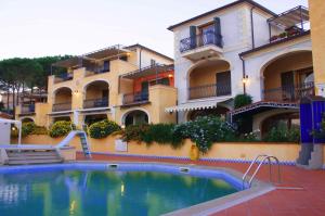 a swimming pool in front of a building at Residence Riva Azzurra in Cannigione