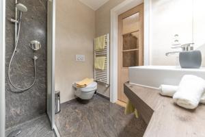 a bathroom with a shower and a toilet and a sink at Gästehaus Brugger Martin in Sölden