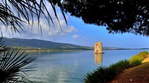 a tower in the middle of a body of water at Il Nido - Casa Vacanze & Galleria d'Arte in Orbetello