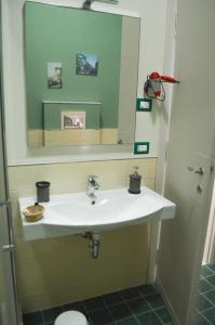 a bathroom with a white sink and a mirror at La fontana de li Papi in Cava deʼ Tirreni
