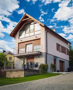 a large white house with a balcony at Dom pod Magurką in Wilkowice
