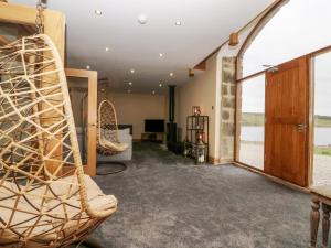 a room with chairs and a large window at Snave Barn in Skipton