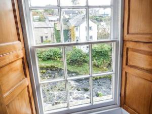 een raam met uitzicht op een tuin bij Bridge End Cottage in Carnforth