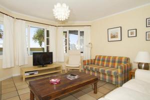 A television and/or entertainment centre at Charming Lanzarote Villa Casa Tingu 3 Bedrooms Heated Private Pool Centre Of Resort Puerto Del Carmen
