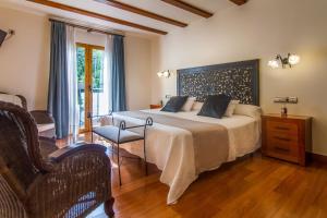 a bedroom with a large bed and a chair at Hotel Tossal d'Altea in Altea