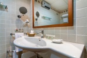 a bathroom with a white sink and a mirror at Hotel Tossal d'Altea in Altea