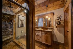 a bathroom with a shower and a sink and a mirror at Winding Log Ridge in Blue Ridge +25 photos