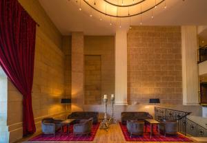 a room with chairs and tables and a red curtain at Catalonia Donosti in Donostia-San Sebastián