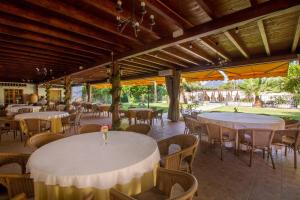 a restaurant with white tables and chairs and tablesearcher at Hotel Tossal d'Altea in Altea