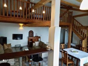 a living room with a table and a dining room at La Fréjade in Lisle-sur-Tarn