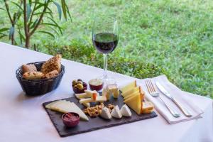 a glass of wine and a plate of cheese and bread at Hotel Tossal d'Altea in Altea