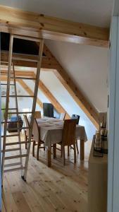 a dining room with a loft bed and a table and chairs at Gästehaus Kamminke in Kamminke