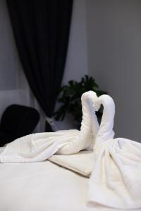 a pair of white swan towels on a table at AcroView Right In The Center in Athens