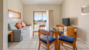 a living room with a table and a couch at Park Royal Homestay Los Cabos in San José del Cabo