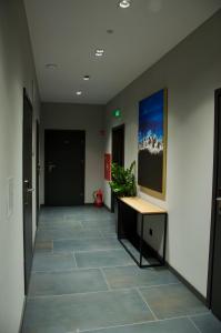 a hallway of an office with a desk and a painting on the wall at Aparts Hotel Radom in Radom