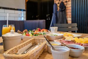 a table topped with bowls and plates of food at Cinema Hostel in Poznań