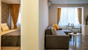 a room with a couch and a bed and a window at Aquarium Apartment Grivita in Bucharest