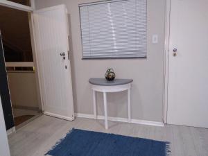 a room with a blue table and a window at 901 Umdloti Beach Resort in Umdloti +11 photos
