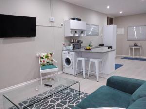a living room with a kitchen and a living room with a couch at 901 Umdloti Beach Resort in Umdloti