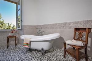 a bath tub in a bathroom with a tile floor at Location prestige 450 m2 dans Château en Provence in Brue-Auriac +28 photos