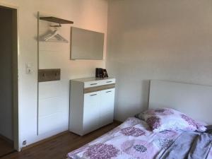 a small bedroom with a bed and a mirror at Bokelrehm 3 in Bokelrehm