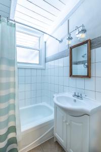 a bathroom with a sink and a tub and a mirror at 2BR Boutique Suite #8 in Blue Mountains