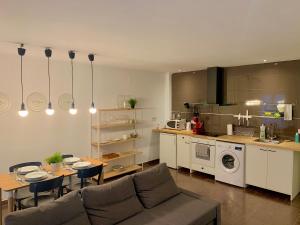 a living room with a couch and a table and a kitchen at Mush Rooms Apartments in Alicante