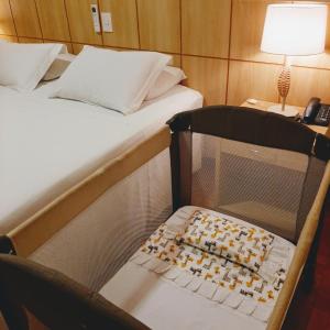 A bed or beds in a room at Serra Negra Palace Hotel