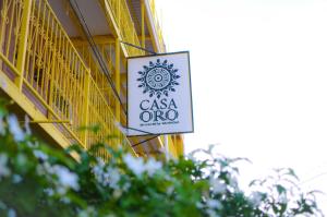 a sign for a casa oneo on the side of a building at Casa Oro Eco Hostel in San Juan del Sur