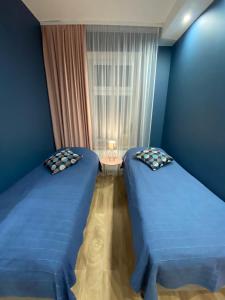 Кровать или кровати в номере Apartamenty Liwa