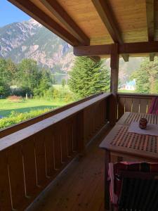 a porch with a table and a view of a mountain at Haus Huberta in Achenkirch