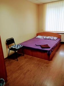a bedroom with a bed and a chair in it at Best4Rest in Kyiv