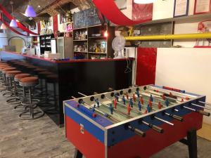 a large foosball table in a bar with a counter at Whole basement former pub for stag do, bachelor House party flat in Budapest