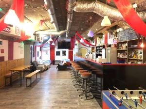 a bar with a lot of stools in a room at Whole basement former pub for stag do, bachelor House party flat in Budapest