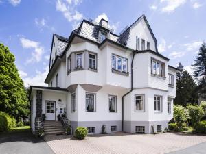 a white house with a black roof at Villa Siegfried in Bad Steben