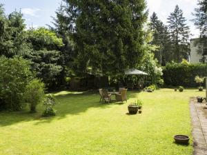 einen Garten mit einem Tisch und Stühlen im Gras in der Unterkunft Villa Siegfried in Bad Steben